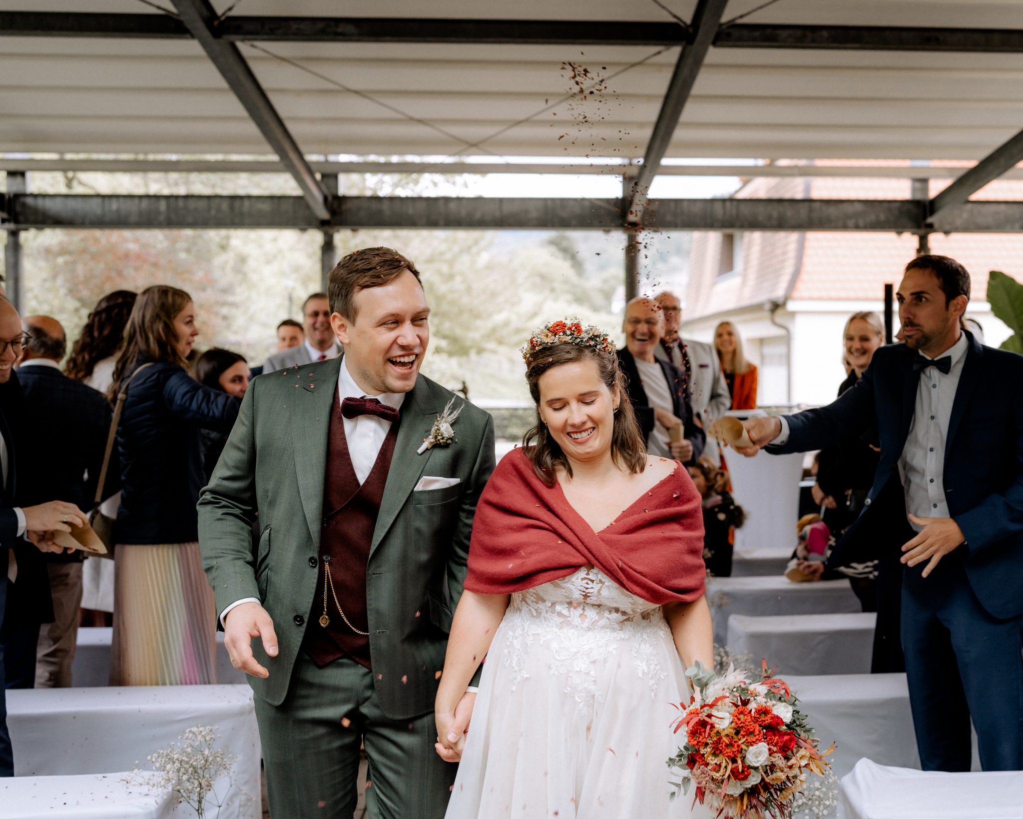 Confetti exit following the celebrant-led ceremony, bride with red stole